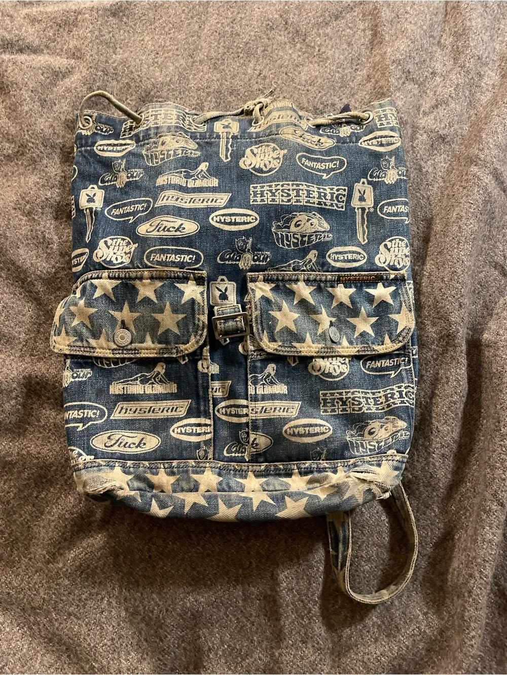 Hysteric Glamour denim backpack with white stars and repeating text graphics